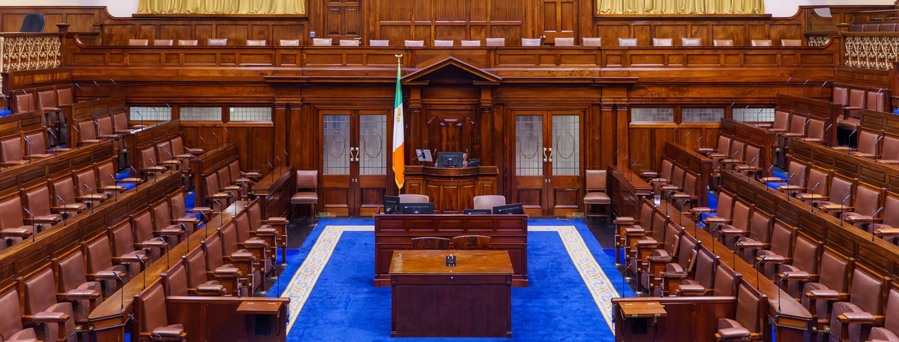 Empty benches and the speaker’s chair in a parliamentary chamber